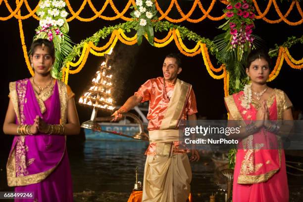 Hindu priests perform the Ganga Aarti ritual in Varanasi. Fire puja is a Hindu ritual that takes place at Dashashwamedh Ghat on the banks of the...