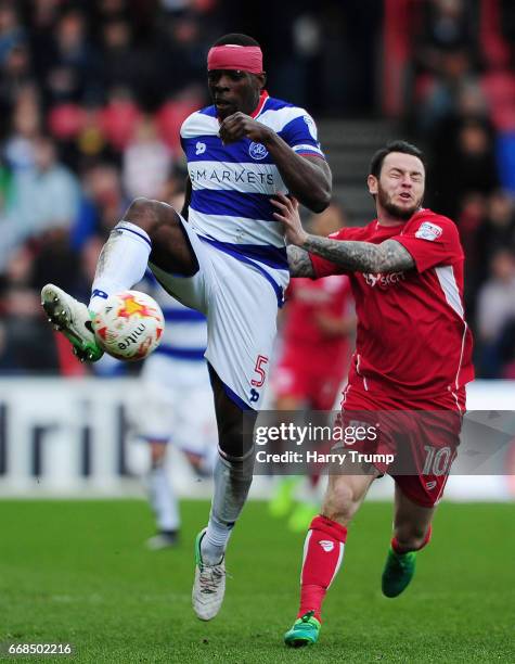 Nedum Onuoha of Queens Park Rangers is tackled by Lee Tomlin of Bristol City during the Sky Bet Championship match between Bristol City and Queens...