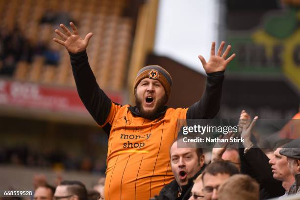 Wolverhampton Wanderers fan waves to the Brighton fans during the Sky Bet Championship match between Wolverhampton Wanderers and Brighton & Hove...