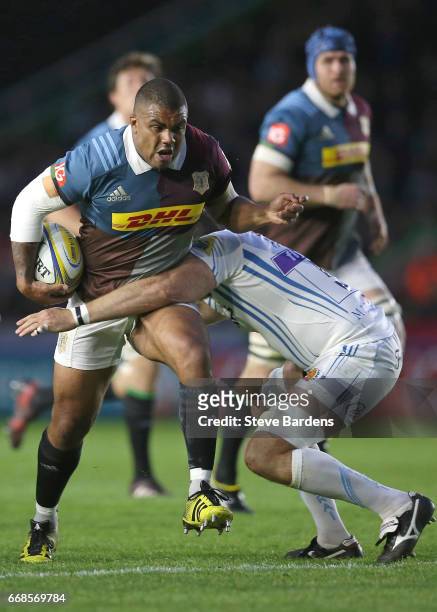 Kyle Sinckler of Harlequins is tackled by Geoff Parling of Exeter Chiefs during the Aviva Premiership match between Harlequins and Exeter Chiefs at...
