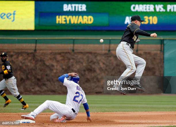 Addison Russell of the Chicago Cubs steals second base as Jordy Mercer of the Pittsburgh Pirates is unable to catch the throw during the fourth...