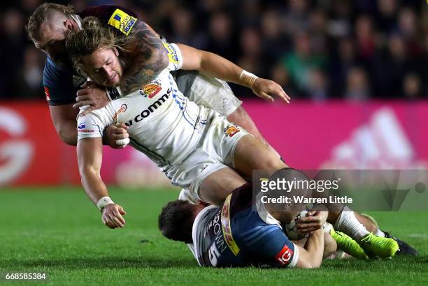 Michele Campagnaro of Exeter Chiefs is tackled off the ball by Joe Marler of Harlequins during the Aviva Premiership match between Harlequins and...