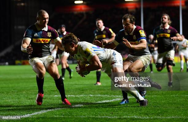 Lachie Turner of Exeter Chiefs dives over for a try under pressure from Mike Brown and Nick Evans of Harlequins during the Aviva Premiership match...