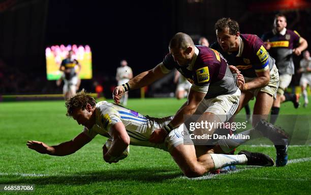 Lachie Turner of Exeter Chiefs dives over for a try under pressure from Mike Brown and Nick Evans of Harlequins during the Aviva Premiership match...
