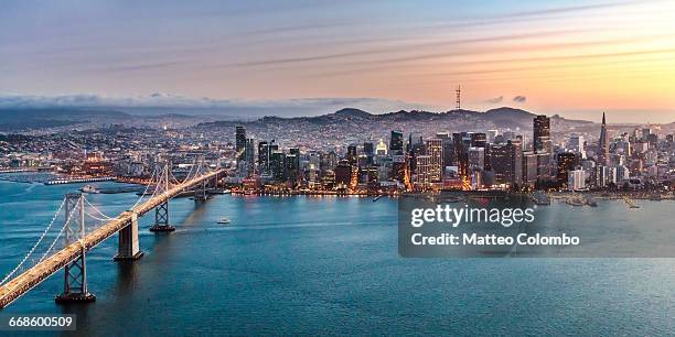 aerial of bay bridge and downtown, san francisco - san francisco oakland bay bridge stockfoto's en -beelden