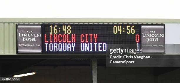 The scoreboard at Lincoln City's Sincil Bank Stadium with less the five minutes remaining, showing the score as Lincoln City 0 - Torquay United 1...