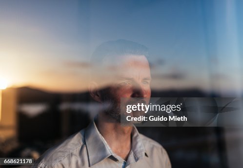 Businessman looking out of a window. Businessman looking out of a window.