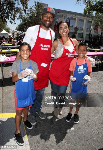 Isaiah Barnes, NBA coach Derek Fisher, Gloria Govan, and Carter Barnes attend Los Angeles Mission's Easter Celebration at Los Angeles Mission on...