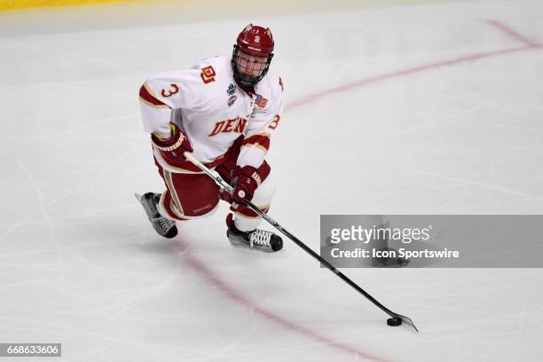 Denver Pioneers defenseman Tariq Hammond controls the puck during an NCAA Frozen Four semifinal game with the Denver Pioneers and the Notre Dame...