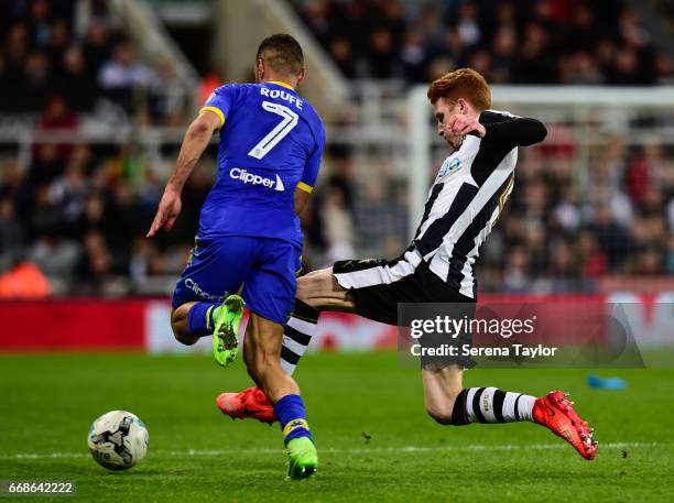 Jack Colback of Newcastle United makes a sliding tackle to win the ball from Kemar Roofe of Leeds United during the Sky Bet Championship Match...