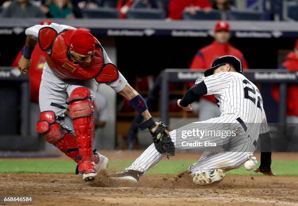 Jacoby Ellsbury of the New York Yankees scores as Yadier Molina of the St. Louis Cardinals is unable to make the tag in the 5th inning on April 14,...