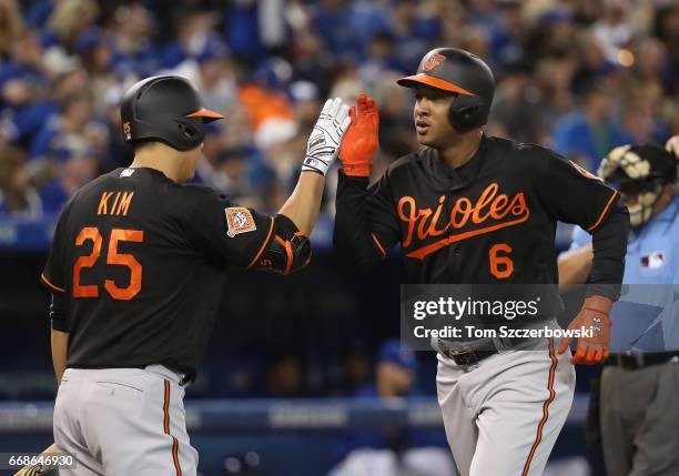 Jonathan Schoop of the Baltimore Orioles is congratulated by Hyun Soo Kim after hitting a solo home run in the fifth inning during MLB game action...