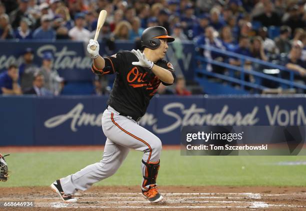 Hyun Soo Kim of the Baltimore Orioles hits a double in the fifth inning during MLB game action against the Toronto Blue Jays at Rogers Centre on...