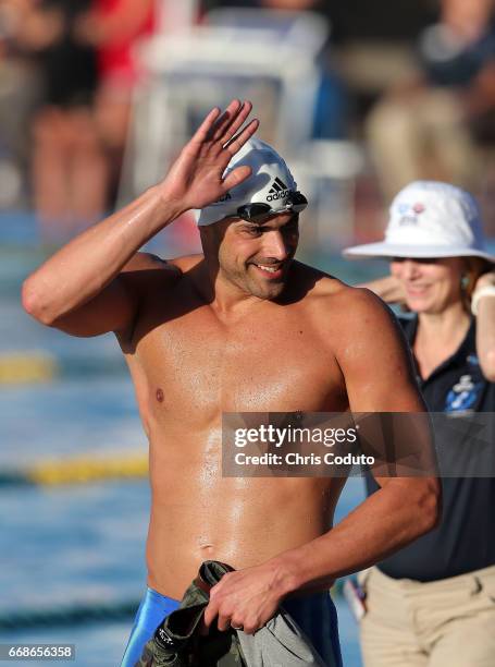 Joao De Lucca waves to the crowd after competing in the the finals of the men's 200 meter freestyle on day two of the Arena Pro Swim Series - Mesa at...