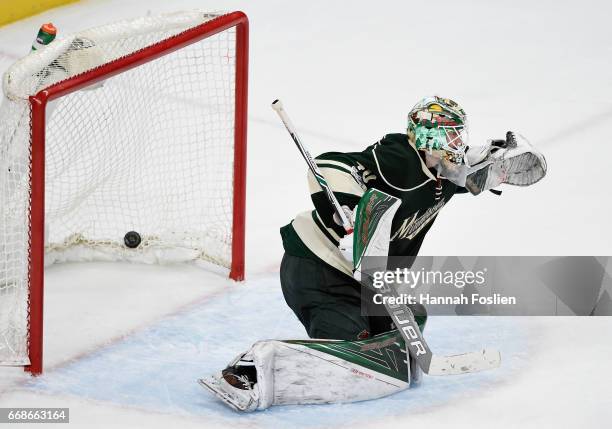 Devan Dubnyk of the Minnesota Wild looks on as a shot by Jaden Schwartz of the St. Louis Blues hits the net to score a goal during the third period...