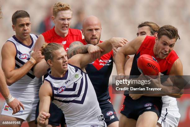 Jack Viney of the Demons handballs during the round four AFL match between the Melbourne Demons and the Fremantle Dockers at Melbourne Cricket Ground...