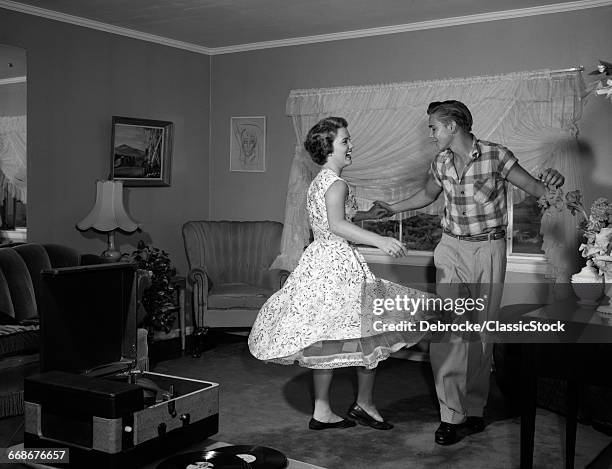 1950s 1960s TEEN COUPLE DANCING JITTERBUG IN LIVING ROOM