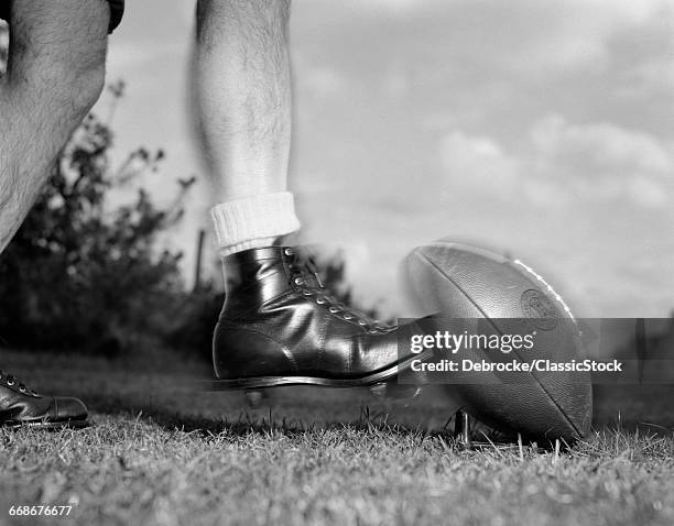 1950s 1960s KICKOFF CLOSE-UP OF FOOT KICKING FOOTBALL