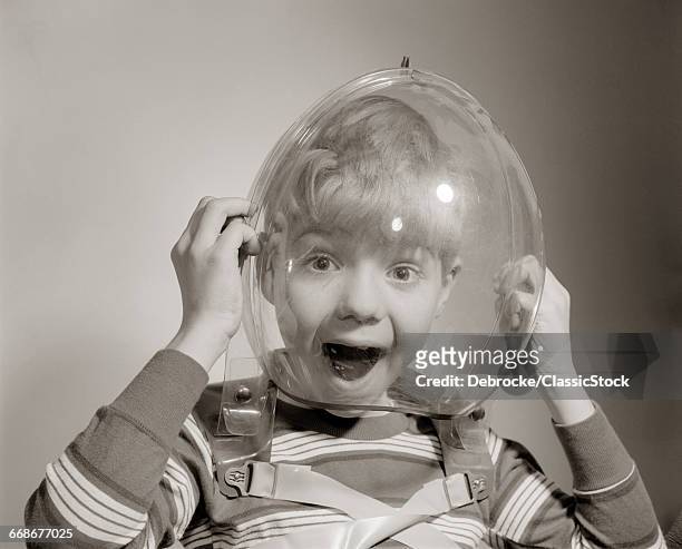 1960s PORTRAIT OF BOY WEARING BUBBLE HELMET