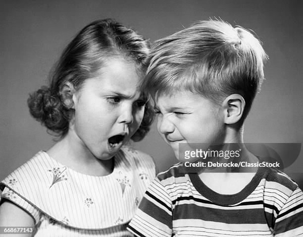 1950s BOY AND GIRL ARGUING HEAD TO HEAD