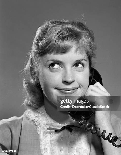 1950s 1960s TEENAGED GIRL TALKING ON TELEPHONE ROLLING EYES SMILING INDOOR