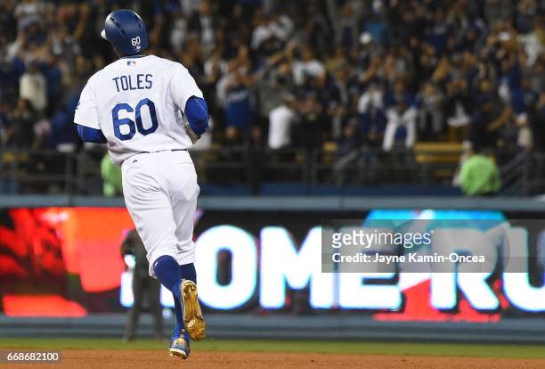 Andrew Toles of the Los Angeles Dodgers rounds the bases after a two run home run in the eighth inning of the game against the Arizona Diamondbacks...
