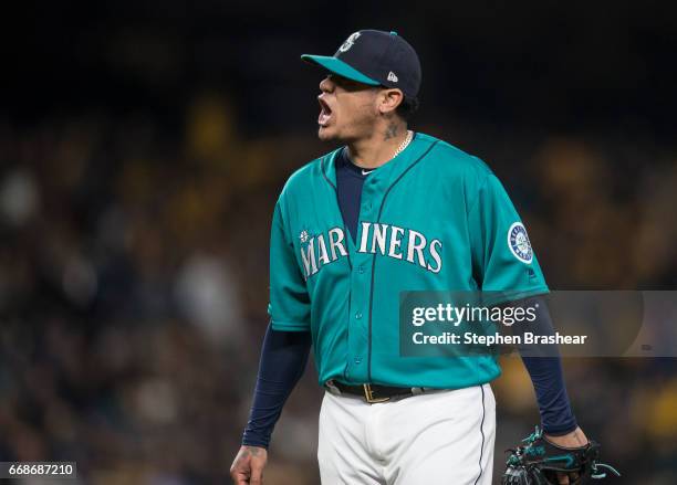 Starting pitcher Felix Hernandez of the Seattle Mariners reacts after pitching the seventh inning of a game against the Texas Rangers at Safeco Field...