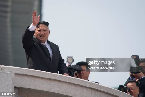 North Korean leader Kim Jong-Un waves from a balcony of the Grand People's Study house following a military parade marking the 105th anniversary of...