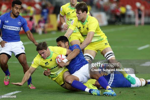 Ed Jenkins of Australia is tackled during the 2017 Singapore Sevens match between Australia and Samoa at National Stadium on April 15, 2017 in...