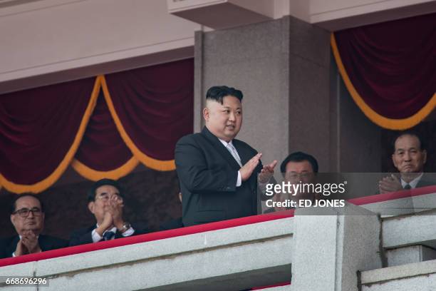 North Korean leader Kim Jong-Un walks on a balcony of the Grand People's Study house following a military parade marking the 105th anniversary of the...