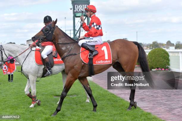 Beau Mertens returns to the mounting yard on Boom Time after winning Robert Taranto Handicap at Caulfield Racecourse on April 15, 2017 in Caulfield,...