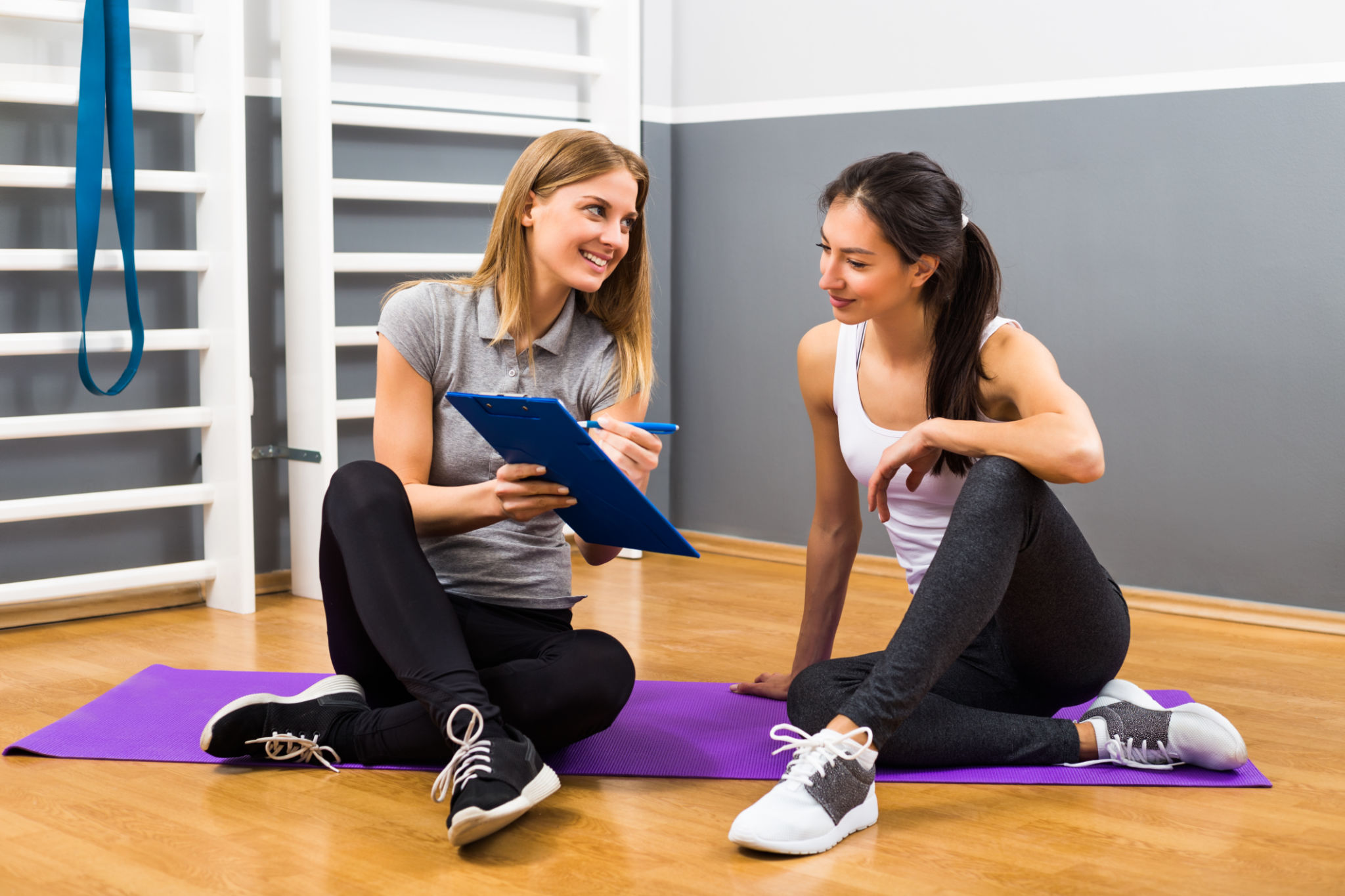 Woman and her personal trainer talking Woman and her personal trainer talking