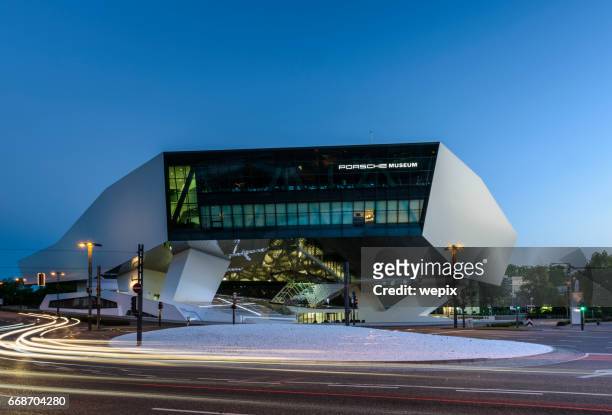 futuristic architecture night traffic blur porsche museum - stuttgart germany stock pictures, royalty-free photos & images
