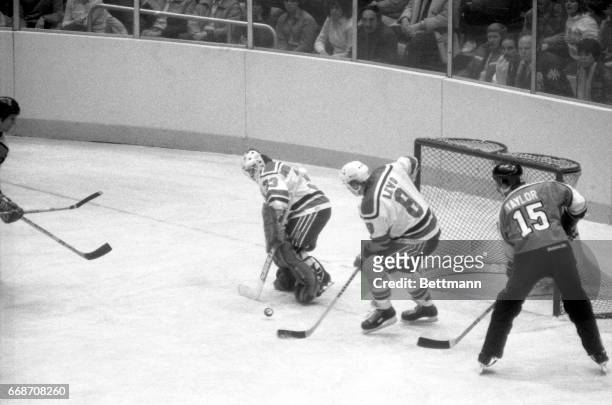 Goalie Lindsay Middlebrook and teammate Tapio Levo of the New Jersey Devils corral the puck to prevent any scoring attempt by mark Taylor of the...