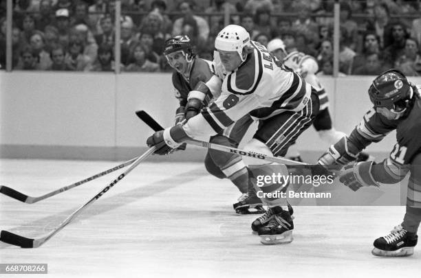 New Jersey’s Tapio Levo is back-checked by Calgary Flames’ Steve Christoff and Dave Hindmarch as Levo skated up the ice with the puck during the...
