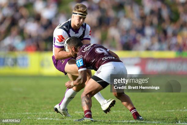 Christian Welch of the Storm is tackled during the round seven NRL match between the Manly Sea Eagles and the Melbourne Storm at Lottoland on April...