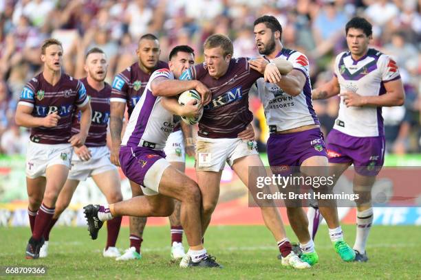 Jake Trbojevic of Manly is tackled during the round seven NRL match between the Manly Sea Eagles and the Melbourne Storm at Lottoland on April 15,...