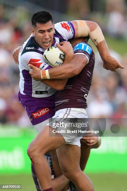 Nelson Asofa-Solomona of the Storm is tackled during the round seven NRL match between the Manly Sea Eagles and the Melbourne Storm at Lottoland on...