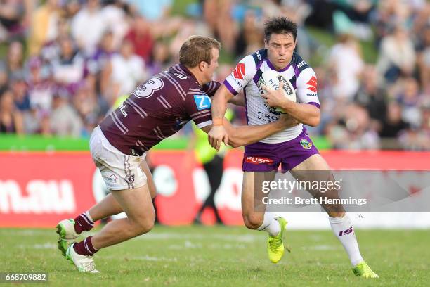 Cooper Cronk of the Storm is tackled during the round seven NRL match between the Manly Sea Eagles and the Melbourne Storm at Lottoland on April 15,...