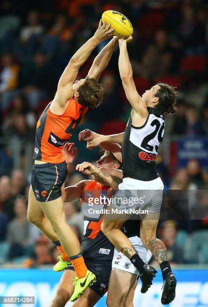 Toby Greene of the Giants and Jasper Pittard of the Power contest a mark during the round four AFL match between the Greater Western Sydney Giants...