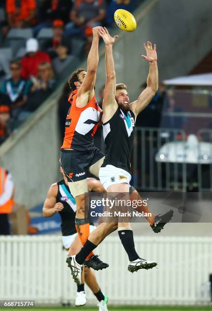 Shane Mumford of the Giants and Jackson Trengove of the Power contest possession during the round four AFL match between the Greater Western Sydney...