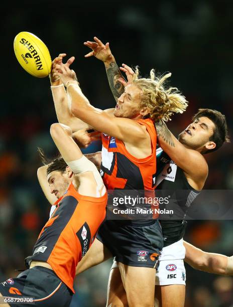 Phil Davis, Nic Haynes and Toby Greene of the Giants contest a mark against Chad Wingard of the Power during the round four AFL match between the...