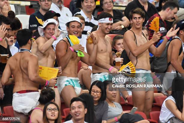 Fans in adult diapers attend the match between New Zealand and Wales during day one of the Singapore Rugby Sevens tournament in Singapore on April...