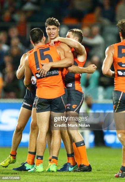 Jonathan Patton of the Giants celebrates kicking a goal with team mates during the round four AFL match between the Greater Western Sydney Giants and...