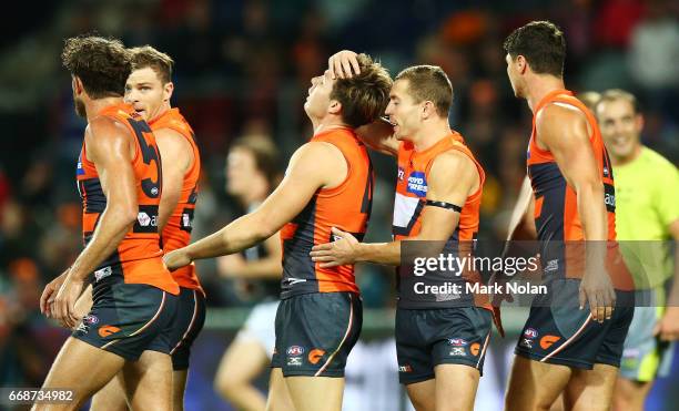 Toby Greene of the Giants celebrates kicking a goal with team mates during the round four AFL match between the Greater Western Sydney Giants and the...