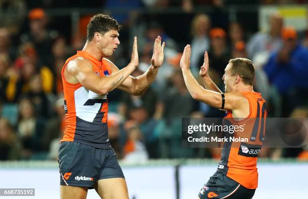 Jonathan Patton of the Giants celebrates kicking a goal with team mates during the round four AFL match between the Greater Western Sydney Giants and...