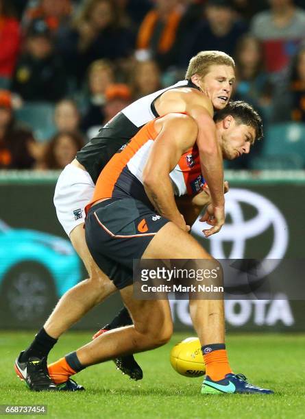 Jared Polec of the Power and Jonathan Patton of the Giants contest a mark during the round four AFL match between the Greater Western Sydney Giants...