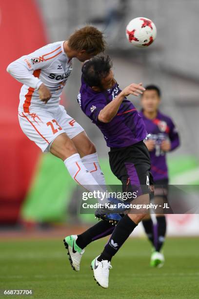 Marcus Tulio Tanaka of Kyoto Sanga and Makoto Rindo of Ehime FC compete for the ball during the J.League J2 match between Kyoto Sanga and Ehime FC at...