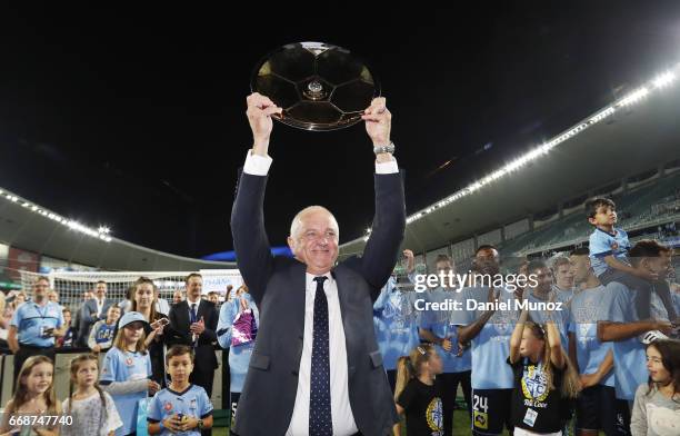 Sydney FC coach Graham Arnold celebrates with the Premiers plate after the round 27 A-League match between Sydney FC and the Newcastle Jets at...