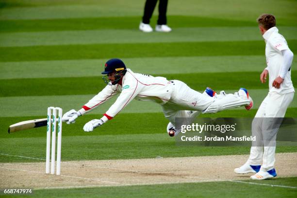 Jordan Clark of Lancashire dives to make his ground during day two of the Specsavers County Championship Division One match between Surrey and...